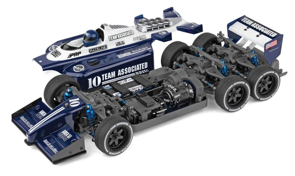 RC10 6x6 body beside chassis